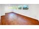 Finished basement with wood-look floors and multiple windows offering backyard views at 144 Morning Creek Rd, Jonesboro, GA 30238