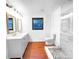 Bright bathroom featuring double vanity, wood flooring, and glass enclosed shower at 144 Morning Creek Rd, Jonesboro, GA 30238
