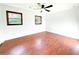 Bright bedroom featuring wood-look floors, two windows, and a ceiling fan at 144 Morning Creek Rd, Jonesboro, GA 30238