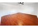 Large bedroom featuring hardwood floors, fresh paint, a ceiling fan, and double closets at 144 Morning Creek Rd, Jonesboro, GA 30238