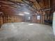 Inside view of the detached garage with concrete floors, overhead lighting, and exposed studs at 144 Morning Creek Rd, Jonesboro, GA 30238