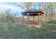 View of the backyard gazebo and its built-in hexagonal table and benches at 144 Morning Creek Rd, Jonesboro, GA 30238