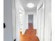 Hallway with hardwood floors and white trim, leading to bathroom at 144 Morning Creek Rd, Jonesboro, GA 30238