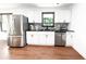 Modern kitchen with stainless steel appliances, white cabinets, and contrasting countertops at 144 Morning Creek Rd, Jonesboro, GA 30238