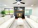 Bright living room featuring a brick fireplace and comfortable white couches at 144 Morning Creek Rd, Jonesboro, GA 30238