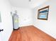 Well lit utility room with water heater, wood flooring and window at 144 Morning Creek Rd, Jonesboro, GA 30238