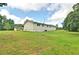 Rear exterior featuring white vinyl siding and a large lawn extending to nearby trees at 24 Echo Ridge Dr, Powder Springs, GA 30127