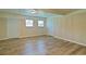 Finished basement features wood-look laminate floors, neutral walls, and multiple doors and windows at 24 Echo Ridge Dr, Powder Springs, GA 30127
