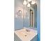 Bathroom with white vanity, sink, framed mirror, and blue painted walls at 24 Echo Ridge Dr, Powder Springs, GA 30127