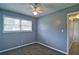 Bedroom featuring neutral carpet, blue painted walls, ceiling fan, and a window at 24 Echo Ridge Dr, Powder Springs, GA 30127