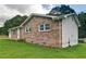 Charming brick home with white trim, surrounded by a lush green lawn and mature trees at 24 Echo Ridge Dr, Powder Springs, GA 30127