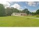 Well-maintained home featuring a large yard, mature trees, and a bright exterior at 24 Echo Ridge Dr, Powder Springs, GA 30127