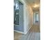 Hallway with light grey laminate floors, and doors leading to other rooms at 24 Echo Ridge Dr, Powder Springs, GA 30127