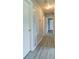Hallway with laminate flooring and neutral paint at 24 Echo Ridge Dr, Powder Springs, GA 30127
