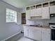 Open kitchen featuring white cabinets and laminate flooring at 24 Echo Ridge Dr, Powder Springs, GA 30127