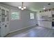 Spacious kitchen with white cabinets, refrigerator and eat-in dining area with natural lighting at 24 Echo Ridge Dr, Powder Springs, GA 30127