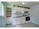 Bright kitchen featuring white cabinets and a pantry for ample storage at 24 Echo Ridge Dr, Powder Springs, GA 30127