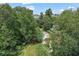 Aerial view of a pool surrounded by lush trees, providing a private and scenic retreat at 3530 Piedmont Ne Rd # K8, Atlanta, GA 30305