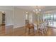 The dining room features wood flooring, a chandelier, and a mirrored wall, adjacent to the living area at 3530 Piedmont Ne Rd # K8, Atlanta, GA 30305