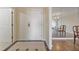 Entryway features neutral tile flooring, a solid wood front door, and a glimpse into the dining room at 3530 Piedmont Ne Rd # K8, Atlanta, GA 30305