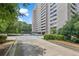 View of building exterior showing a covered parking area with well-maintained landscaping and manicured bushes at 3530 Piedmont Ne Rd # K8, Atlanta, GA 30305
