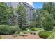 High rise condo building with lush landscaping and walking paths surrounded by mature trees at 3530 Piedmont Ne Rd # K8, Atlanta, GA 30305