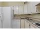 Clean kitchen with white cabinets and appliances including a dishwasher at 3530 Piedmont Ne Rd # K8, Atlanta, GA 30305