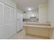 Eat-in kitchen featuring white appliances, white cabinets and an eat-at peninsula bar at 3530 Piedmont Ne Rd # K8, Atlanta, GA 30305