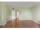 Open living room with hardwood floors leading to an open door, offering seamless transitions and modern living at 3530 Piedmont Ne Rd # K8, Atlanta, GA 30305