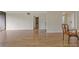 Open-concept living area boasts wood floors and a view into the dining room and hallway at 3530 Piedmont Ne Rd # K8, Atlanta, GA 30305