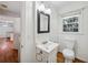 Bright bathroom features a white vanity, black framed mirror, and a window for natural light at 4984 Wickford Way, Atlanta, GA 30338