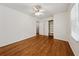 Bedroom featuring hardwood floors, a ceiling fan, and closet with built-in shelves at 4984 Wickford Way, Atlanta, GA 30338