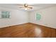 Large bedroom with hardwood floors, ceiling fan, and ample natural light at 4984 Wickford Way, Atlanta, GA 30338