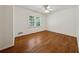 This is a bedroom featuring hardwood floors, a ceiling fan and natural light at 4984 Wickford Way, Atlanta, GA 30338
