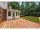 The home features a wooden deck with railing and steps leading to the backyard at 4984 Wickford Way, Atlanta, GA 30338