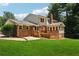 The backyard of this brick home includes a sunroom, wood deck, and a patio area at 4984 Wickford Way, Atlanta, GA 30338