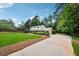 Exterior view of home featuring a side-entry garage, and lush landscaping at 4984 Wickford Way, Atlanta, GA 30338