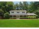 Charming two-story home boasts a brick facade, manicured lawn, and lush landscaping at 4984 Wickford Way, Atlanta, GA 30338