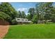 Charming two-story home features a well-manicured lawn, and mature trees at 4984 Wickford Way, Atlanta, GA 30338