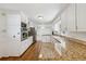 Open-concept kitchen with granite countertops, modern appliances, and hardwood floors at 4984 Wickford Way, Atlanta, GA 30338