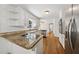Modern kitchen boasts granite countertops, stainless steel appliances, and hardwood floors at 4984 Wickford Way, Atlanta, GA 30338
