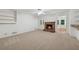 Spacious living room features a cozy fireplace, built-in shelving, and a ceiling fan at 4984 Wickford Way, Atlanta, GA 30338