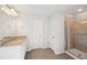 Modern bathroom features a shower, vanity with granite countertop, and neutral tile floors at 11847 Rizvan Pl, Covington, GA 30014