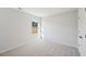 Bright bedroom features neutral carpet, fresh paint, and a sun-filled window overlooking the outdoors at 11847 Rizvan Pl, Covington, GA 30014