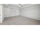 Open bedroom offers neutral carpet, ceiling fan, and great natural light at 11847 Rizvan Pl, Covington, GA 30014