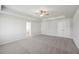 Expansive bedroom boasts soft carpet, ceiling fan, and view to the Primary bathroom at 11847 Rizvan Pl, Covington, GA 30014