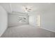 Spacious bedroom featuring plush carpet, ceiling fan, tray ceiling, and bright natural light at 11847 Rizvan Pl, Covington, GA 30014