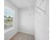 Bright walk-in closet with window and wire shelving for optimized organization at 11847 Rizvan Pl, Covington, GA 30014