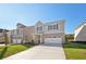 Attractive two-story home with brick accents and a spacious driveway at 11847 Rizvan Pl, Covington, GA 30014