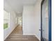 Bright hallway featuring wood-look floors and fresh, neutral paint at 11847 Rizvan Pl, Covington, GA 30014